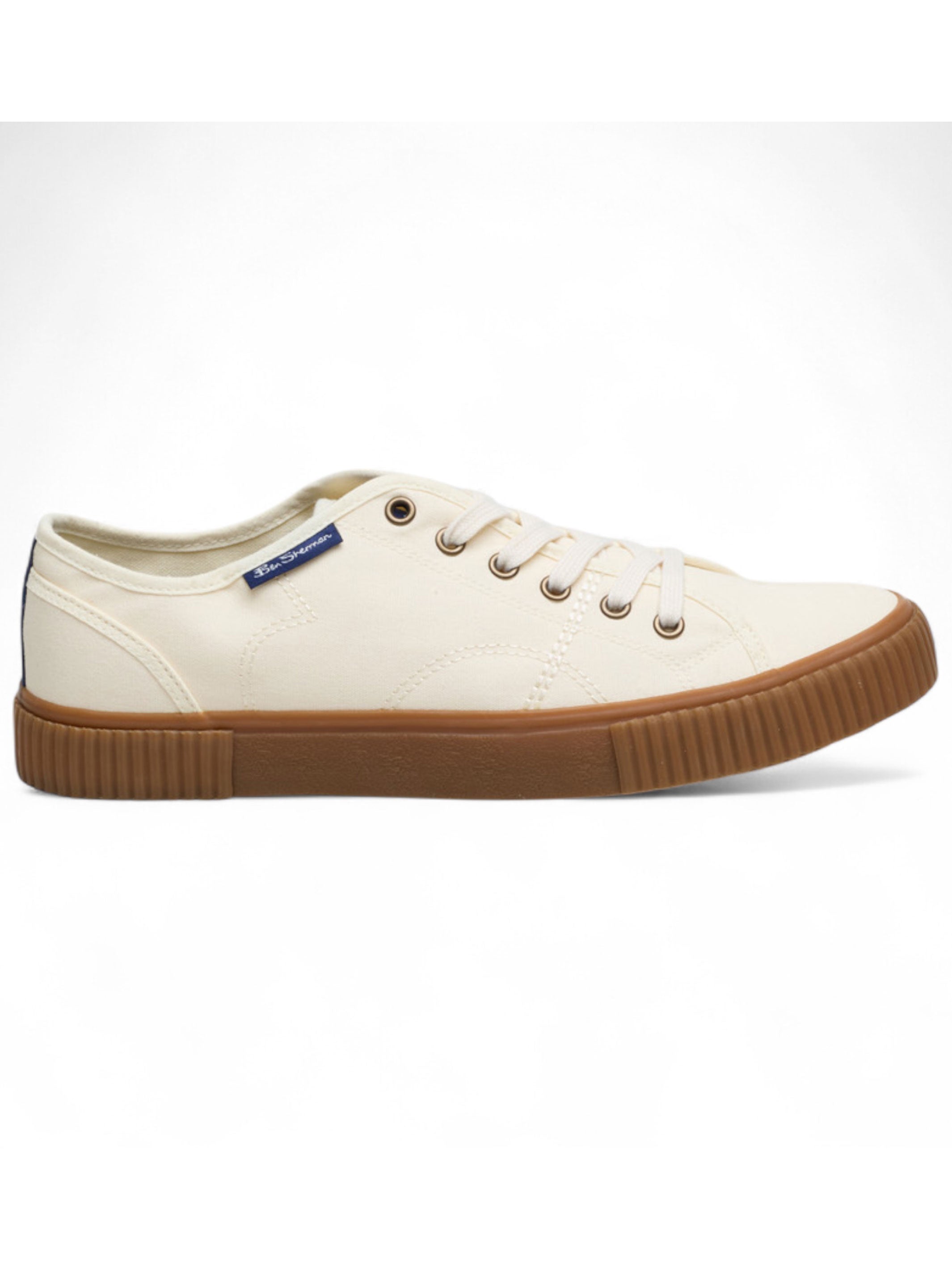 White sneaker with brown sole on a white background