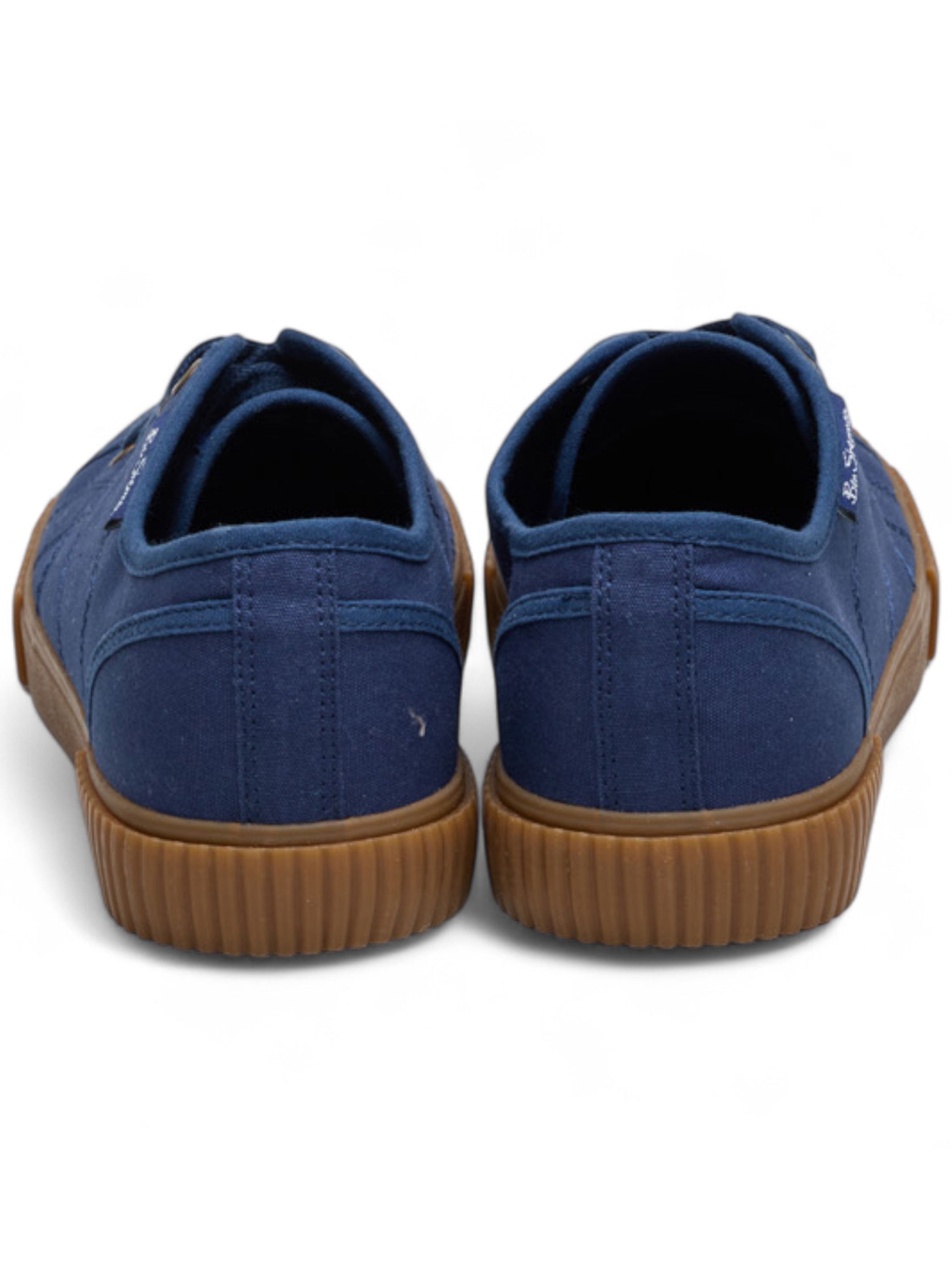 Pair of blue sneakers with brown soles on a white background