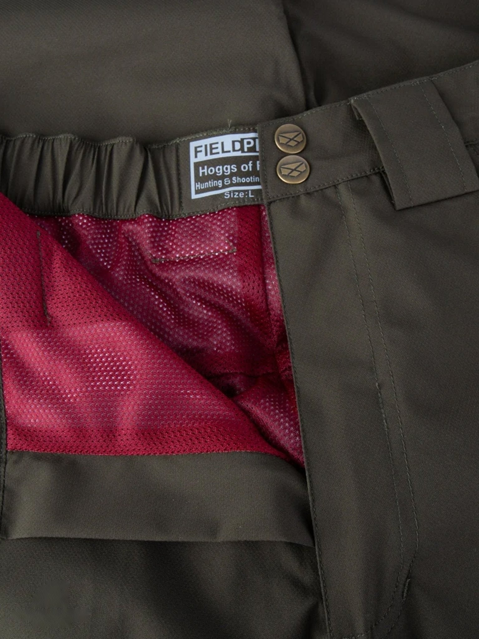 Close-up of a brown trouser with a visible brand label on the inner waistband.