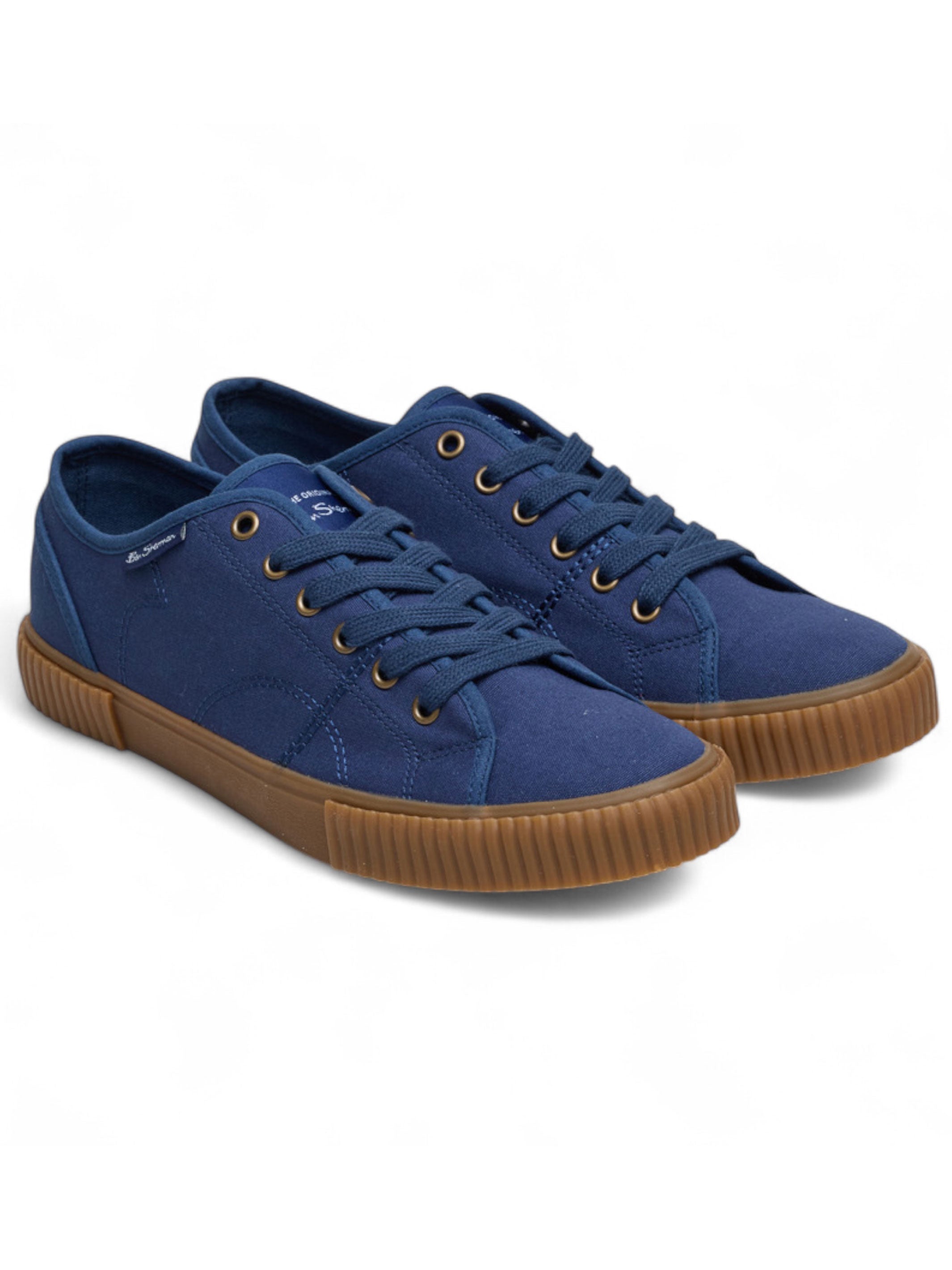 Pair of blue sneakers with brown soles on a white background