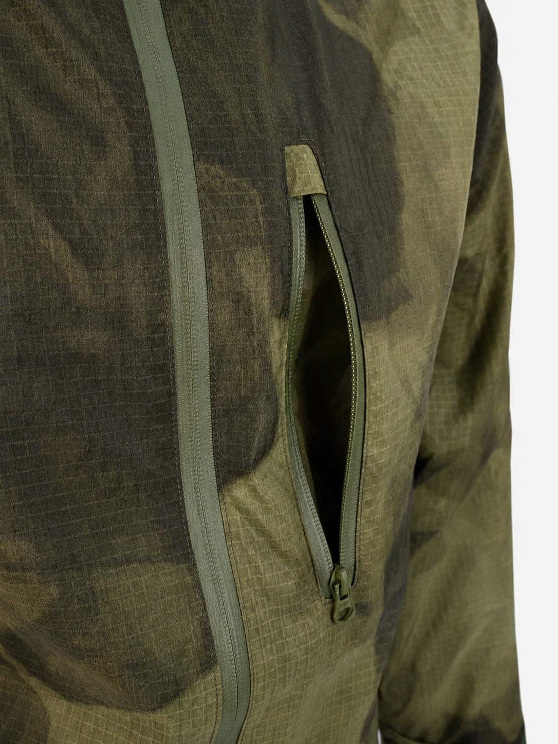 Close-up of a green camouflage jacket with a zipper on a white background