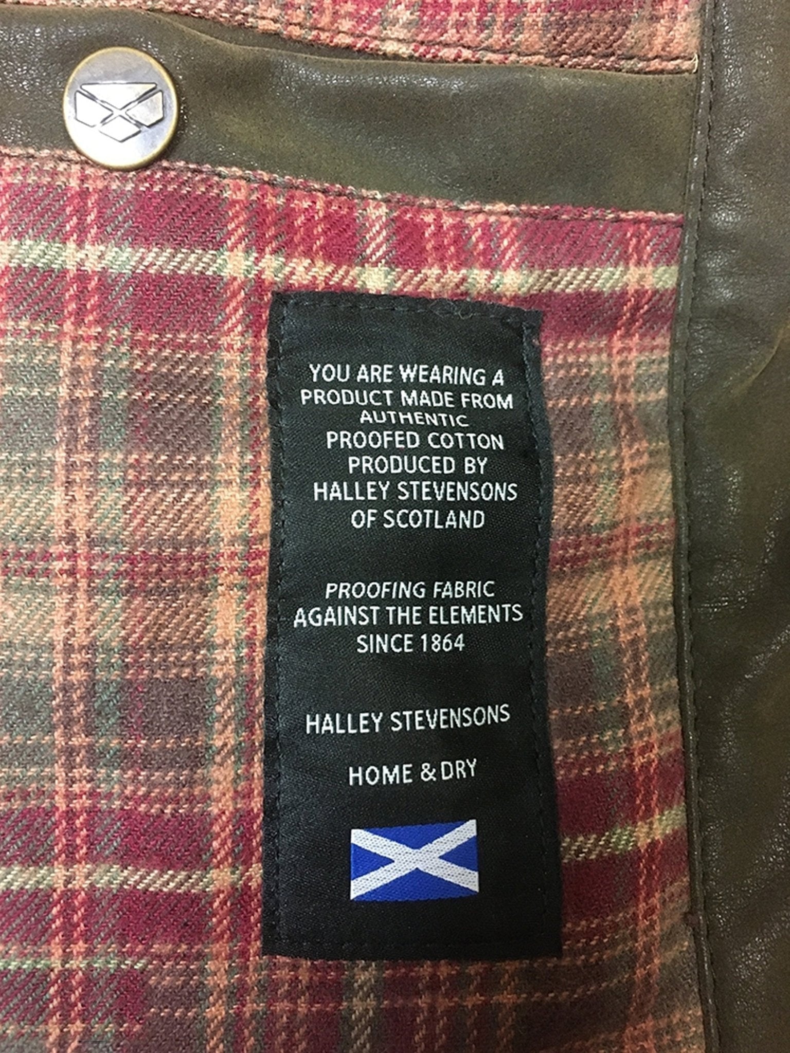 Label on a plaid fabric product with text and a flag design, featuring Halley Stevenson's branding.