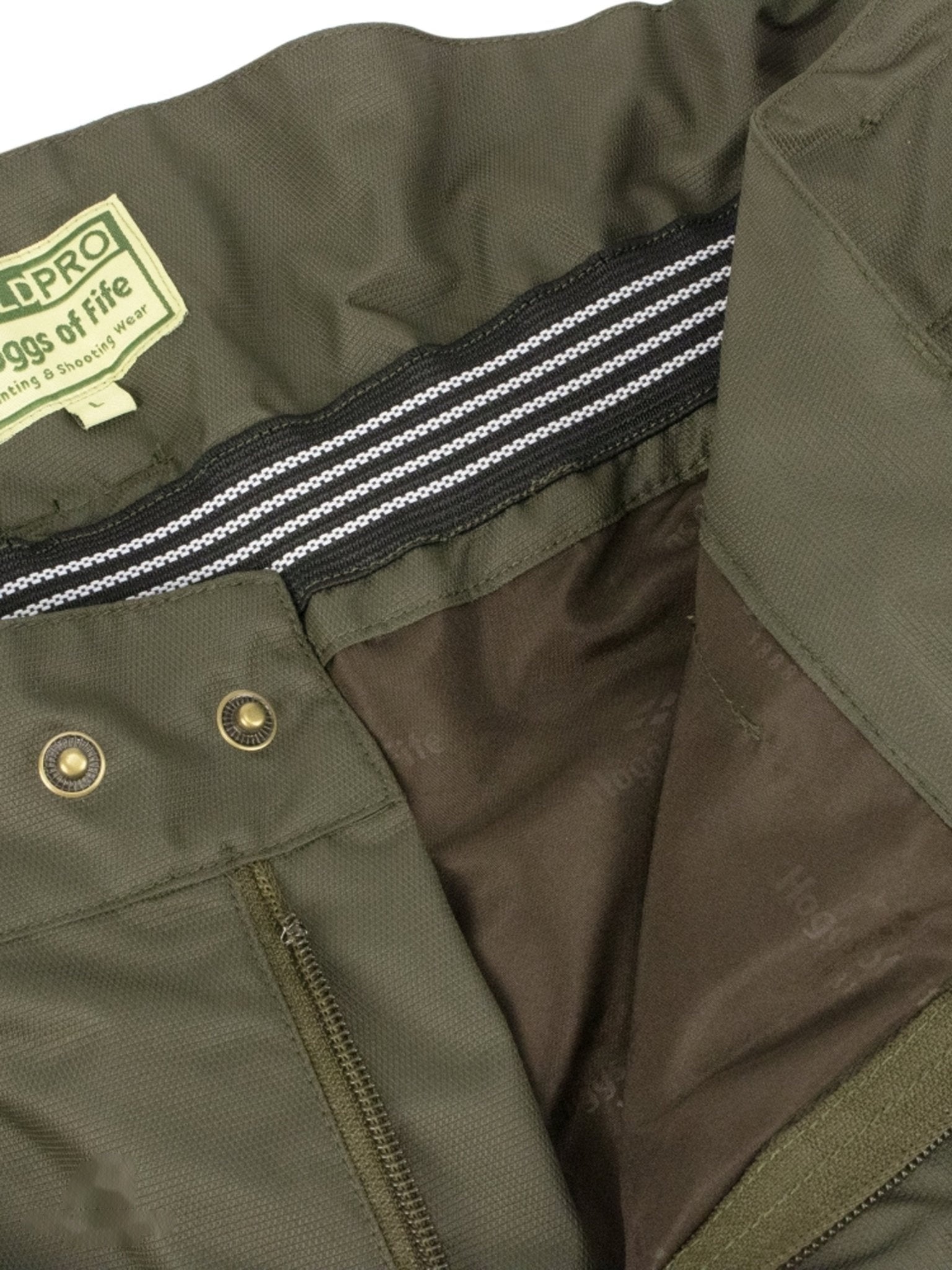 Close-up of a green trouser with a brand label and zipper details.