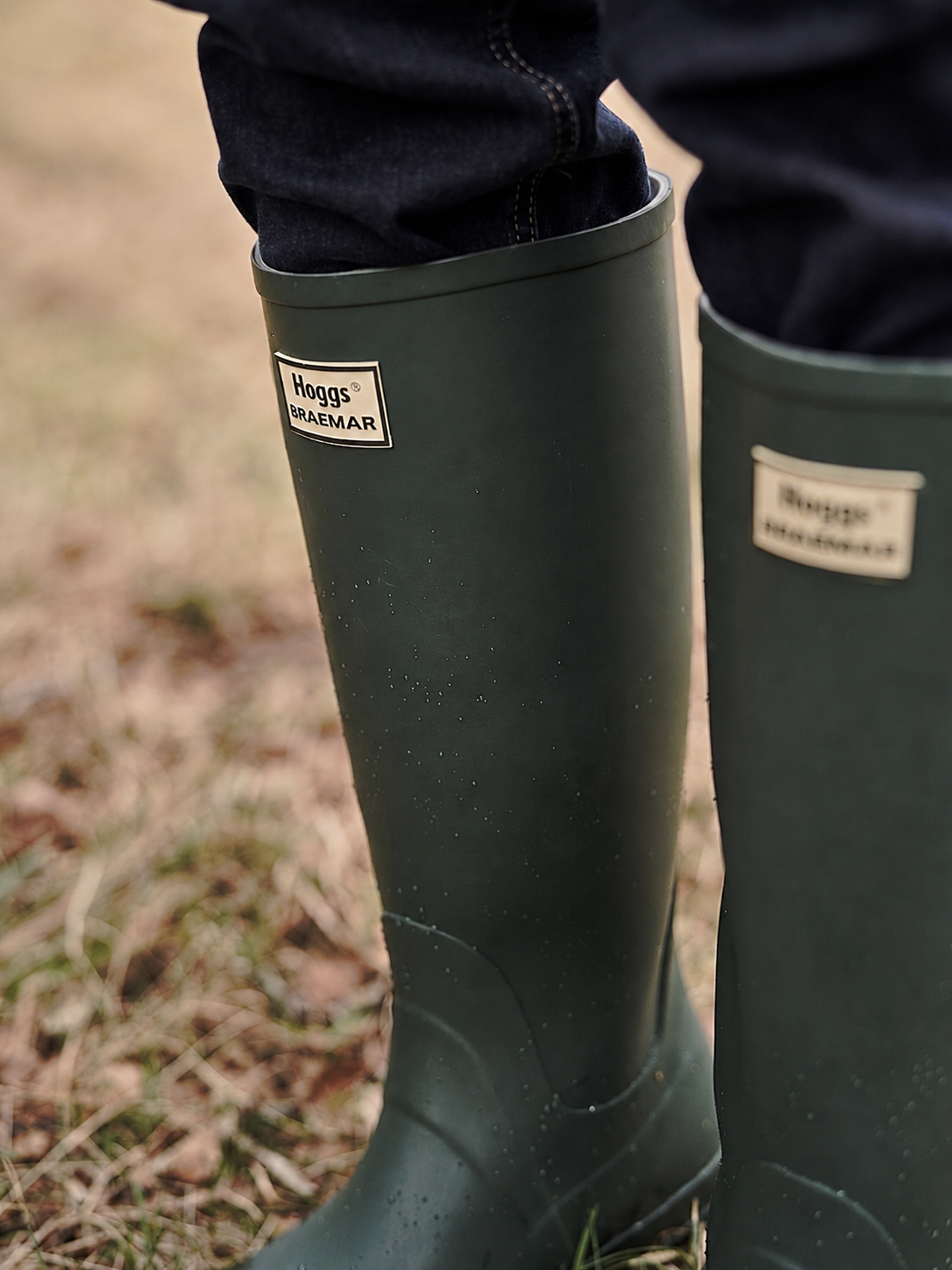 Green wellington boots with Hoggs of Fife branding on a natural background