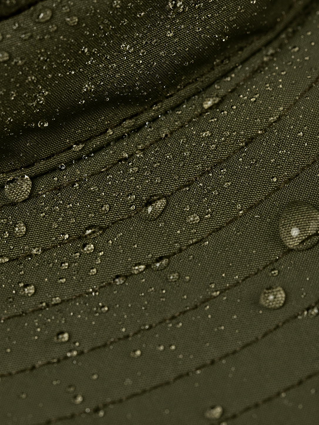 Close-up of a green fabric with water droplets on it